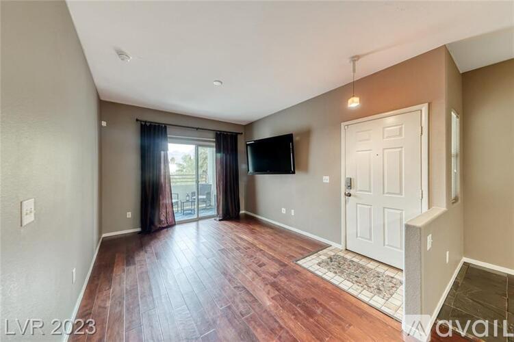 A living room with a flat screen TV mounted on the wall.