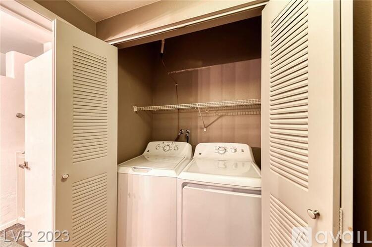 A small laundry room with two washing machines.