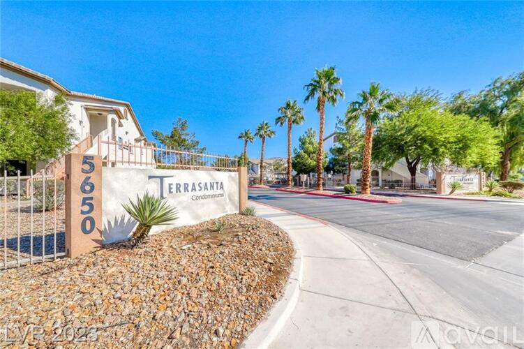 A sign for Terra Santa Condos is in front of a building with a palm tree.