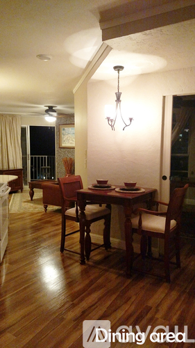 A dining room with a wooden table and chairs.