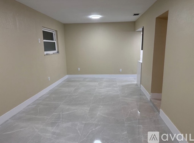 A room with a marble floor and a window.