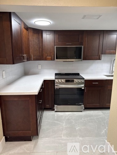 A kitchen with a stove top oven and a microwave.