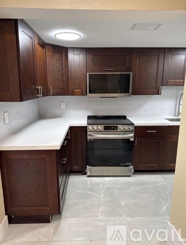 A kitchen with a stove top oven and a microwave.