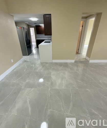 A kitchen with a marble floor and a logo that reads "avaiL".