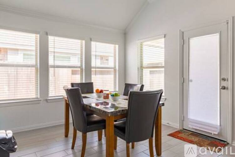 A dining room with a glass table and chairs.