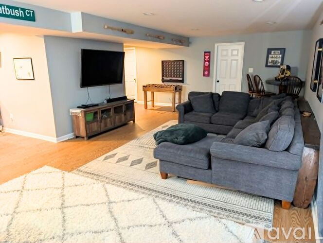 A living room with a grey couch and a wooden coffee table.