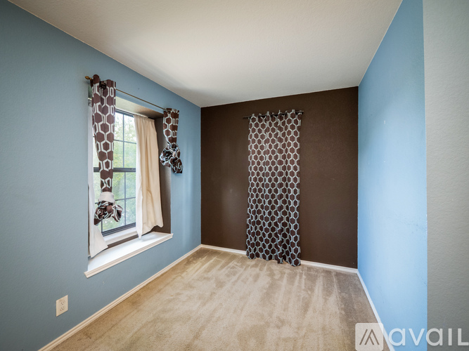 A room with a window and a curtain with a giraffe print.