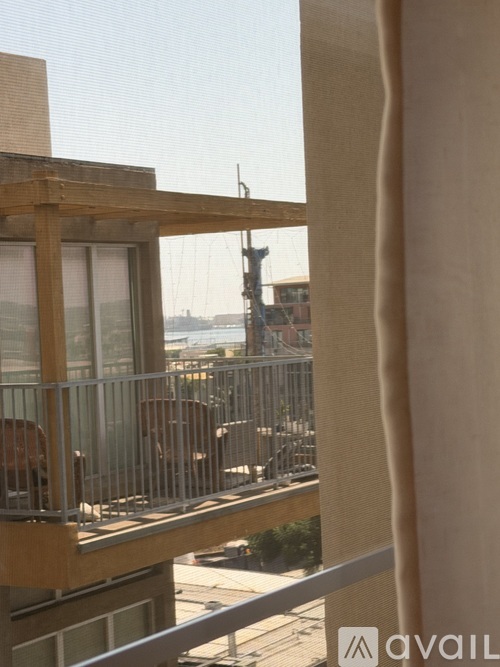 A balcony with a railing and a view of the city.