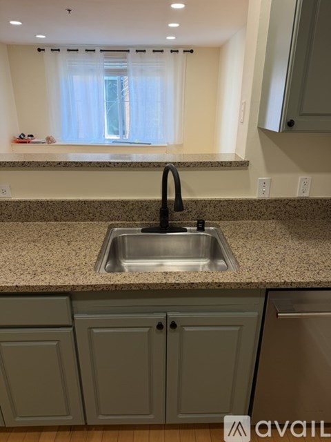 A kitchen with a sink and cabinets.