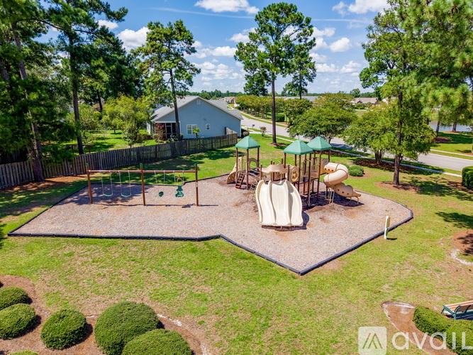A playground with a slide and swings in a backyard.