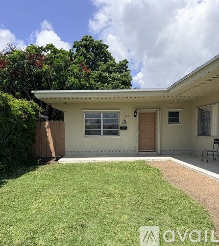 A house with a brown door and a white wall is for sale.
