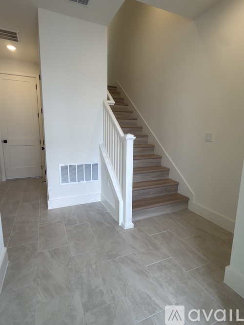 A staircase with a white railing and wooden steps.