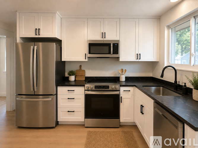 A kitchen with white cabinets and a stainless steel refrigerator.
