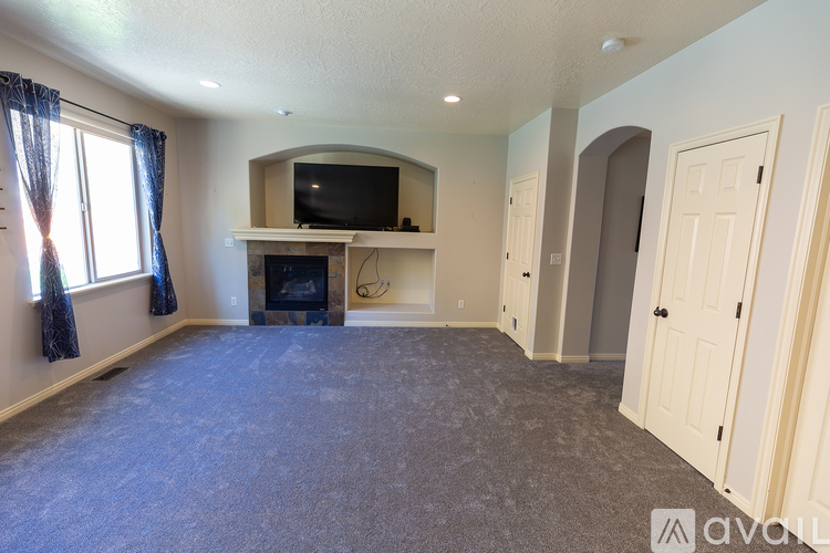 A living room with a fireplace and a television.