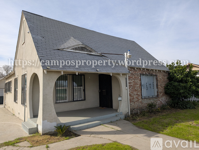 A house with a grey roof and a white entrance area.