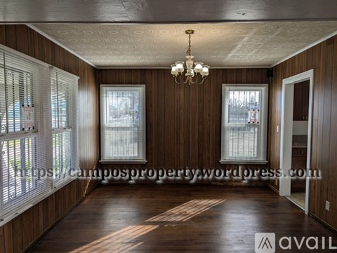 A room with wooden walls and a chandelier hanging from the ceiling.