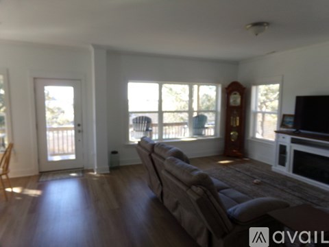 A living room with a couch and a television.