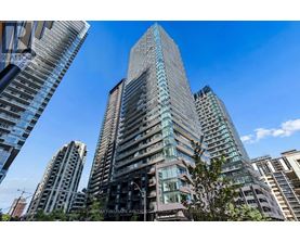 A tall building with many windows is the main focus of this image.