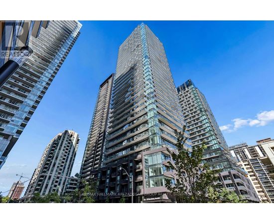 A tall building with many windows is the main focus of this image.