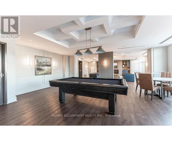 A pool table in a well lit room with a light wood floor.