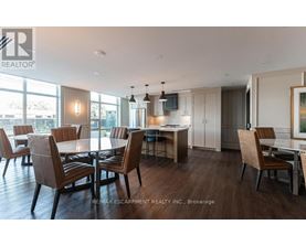 A modern dining room with a large table and chairs.