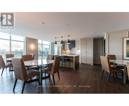 A modern dining room with a large table and chairs.
