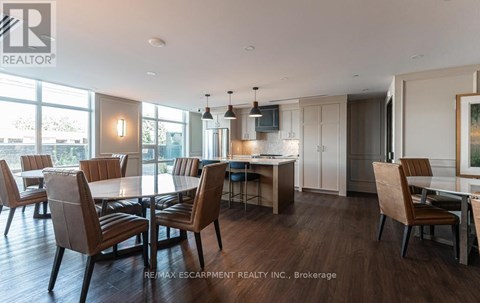 A modern dining room with a large table and chairs.