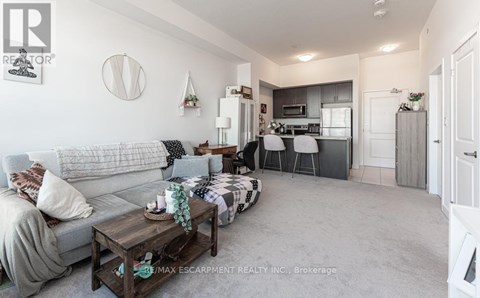 A living room with a grey couch and a coffee table.