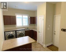A laundry room with a washer and dryer in it.
