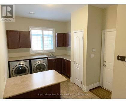 A laundry room with a washer and dryer in it.