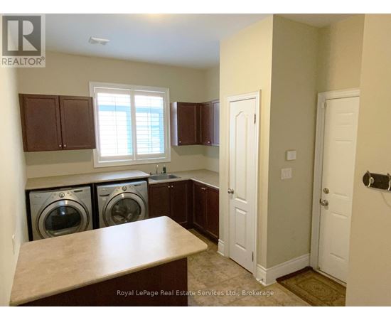 A laundry room with a washer and dryer in it.
