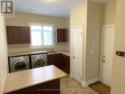 A laundry room with a washer and dryer in it.