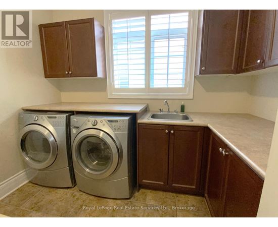 A laundry room with a washer and dryer in it.