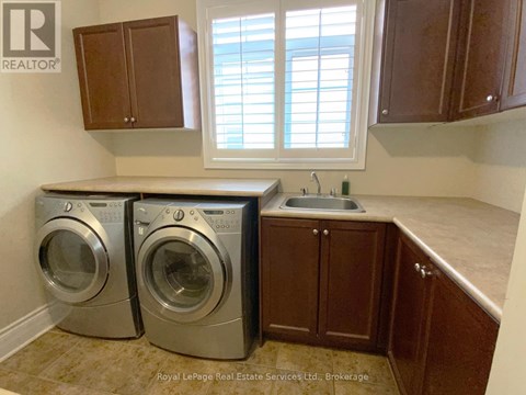 A laundry room with a washer and dryer in it.