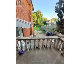 A balcony with a railing and a purple object on the ground.