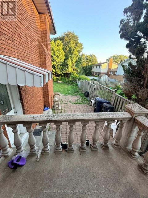 A balcony with a railing and a purple object on the ground.