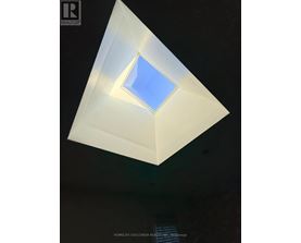 A triangular prism with a blue square in the middle.