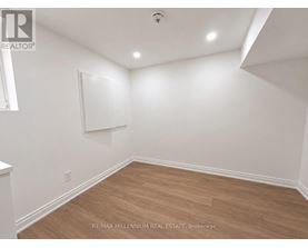 A room with white walls and wooden flooring.