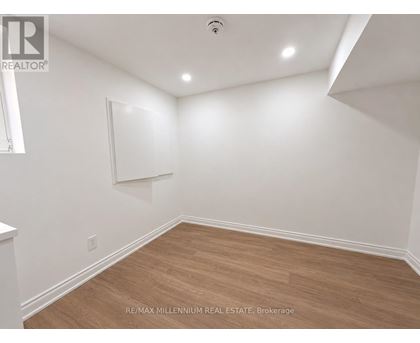 A room with white walls and wooden flooring.