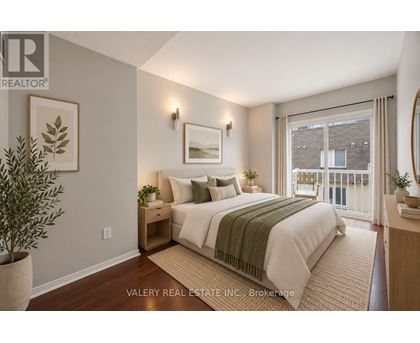 A bedroom with a bed, nightstand, and a plant.