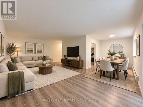 A modern living room with a couch, coffee table, and television.
