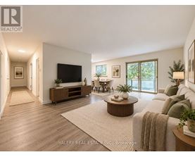 A living room with a flat screen TV, a sofa, and a coffee table.