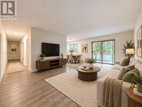 A living room with a flat screen TV, a sofa, and a coffee table.
