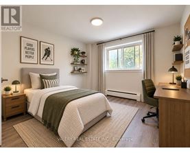 A bedroom with a bed, desk, and chair.