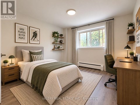 A bedroom with a bed, desk, and chair.