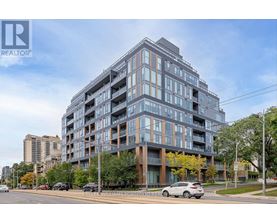 A modern multi-story building with a glass facade is the main focus of the image.