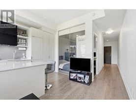 A modern bedroom with a large bed and a flat screen TV.