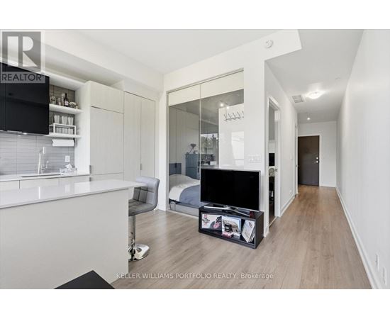 A modern bedroom with a large bed and a flat screen TV.