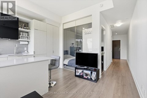 A modern bedroom with a large bed and a flat screen TV.