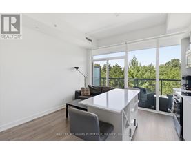 A well-lit, modern dining room with a glass table and chairs.